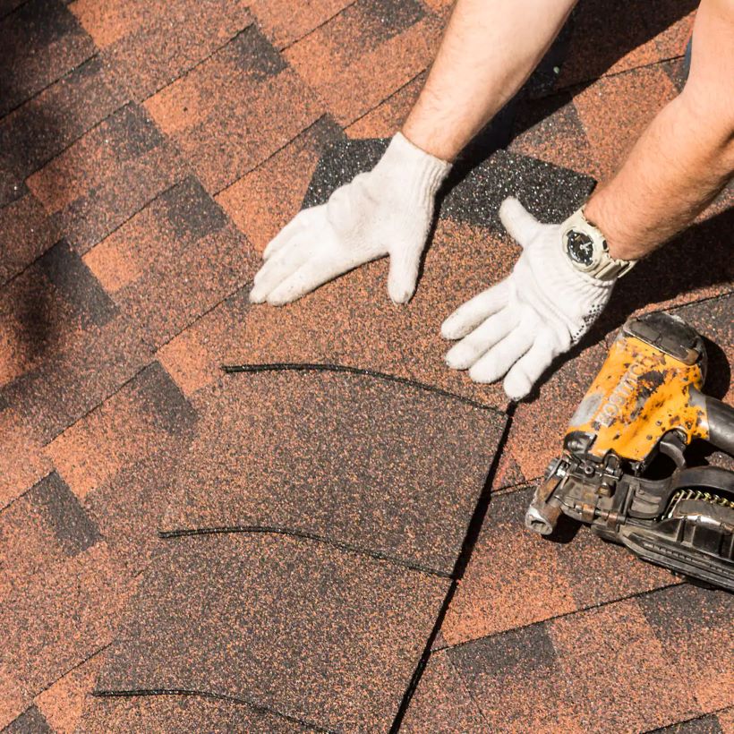  Brown Asphalt shingles being repaired on residential home