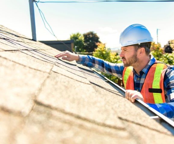 Stock image of roof inspector performing routine inspection